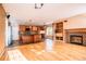 Open-concept kitchen and living area boasts hardwood floors, a fireplace, and modern appliances at 10154 Fairgate Way, Highlands Ranch, CO 80126