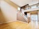 Bright living room showcasing gleaming hardwood floors and a beautiful staircase at 10154 Fairgate Way, Highlands Ranch, CO 80126