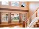 Spacious living room features hardwood floors, large windows, and a staircase at 10154 Fairgate Way, Highlands Ranch, CO 80126
