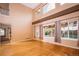 Bright living room featuring hardwood floors, vaulted ceilings, and large windows overlooking the backyard at 10154 Fairgate Way, Highlands Ranch, CO 80126