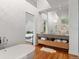 Primary bathroom with a soaking tub, vanity with drawers, and modern light fixtures at 360 S Ogden St, Denver, CO 80209