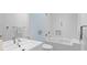 Clean bathroom featuring a white vanity, toilet, and shower-tub combo with white tile at 360 S Ogden St, Denver, CO 80209