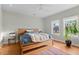 Cozy bedroom with hardwood floors, large windows, and a comfortable bed with a blue duvet at 360 S Ogden St, Denver, CO 80209