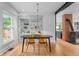Dining room with modern light fixture, dining table, and chairs, next to the kitchen at 360 S Ogden St, Denver, CO 80209