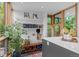 Bright entryway with bench and storage next to a large window overlooking a landscaped yard at 360 S Ogden St, Denver, CO 80209