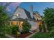 Charming two-story home featuring a gabled roof, a covered front porch, and mature landscaping at 360 S Ogden St, Denver, CO 80209