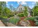 Charming home exterior featuring a garden with blooming irises and a lush, green lawn at 360 S Ogden St, Denver, CO 80209