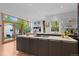 Bright kitchen boasting wooden floors, an island with gray cabinets, and a view of the outdoors at 360 S Ogden St, Denver, CO 80209
