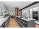 Open kitchen featuring an island with grey cabinets, white countertop, and stainless steel appliances at 360 S Ogden St, Denver, CO 80209