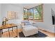 Cozy living area features an accent chair, side table, desk and large window with natural light at 360 S Ogden St, Denver, CO 80209