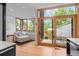 Open living area with wood floors, a sliding door to a deck and view of the landscaped yard at 360 S Ogden St, Denver, CO 80209