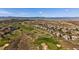 Expansive aerial view showcasing the community's golf course, surrounding landscape, and mountain views at 6772 Vista Lodge Loop, Castle Pines, CO 80108