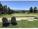 Serene view of the golf course from the backyard, complete with Adirondack chairs at 6772 Vista Lodge Loop, Castle Pines, CO 80108