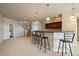 Finished basement features a bar area with stools, cabinetry, and stairs leading to the main level at 6772 Vista Lodge Loop, Castle Pines, CO 80108