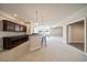 Open basement living area featuring a bar with stools and modern cabinetry with an open doorway at 6772 Vista Lodge Loop, Castle Pines, CO 80108