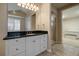 Bathroom with walk-in shower, granite countertop, and white cabinetry at 6772 Vista Lodge Loop, Castle Pines, CO 80108