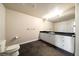 Modern bathroom featuring a toilet, dark tile floor, and a white vanity with a black countertop at 6772 Vista Lodge Loop, Castle Pines, CO 80108