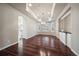 Bright dining room with hardwood floors, custom shutters, and elegant chandelier at 6772 Vista Lodge Loop, Castle Pines, CO 80108