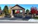 Community entrance with stone pillars, gated entry, and manicured landscaping on a sunny day at 6772 Vista Lodge Loop, Castle Pines, CO 80108