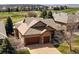 Stunning exterior view of a home featuring a well-manicured lawn, a two-car garage, and a beautiful roof at 6772 Vista Lodge Loop, Castle Pines, CO 80108
