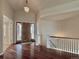 Elegant foyer with hardwood floors, a wooden front door, and a staircase with white banisters at 6772 Vista Lodge Loop, Castle Pines, CO 80108