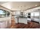 Spacious kitchen with stainless steel appliances, island, and access to a deck at 6772 Vista Lodge Loop, Castle Pines, CO 80108