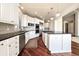 Bright kitchen featuring stainless steel appliances, island with range, and white cabinets at 6772 Vista Lodge Loop, Castle Pines, CO 80108