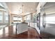 Modern kitchen featuring a center island with hardwood floors, stainless steel appliances, and white cabinetry at 6772 Vista Lodge Loop, Castle Pines, CO 80108