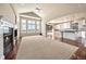 Bright open living area with vaulted ceiling, fireplace, and access to outdoor deck at 6772 Vista Lodge Loop, Castle Pines, CO 80108