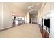 Bright, open living space with fireplace, access to kitchen, and large windows at 6772 Vista Lodge Loop, Castle Pines, CO 80108