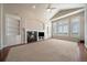 Spacious living room with fireplace, built-in bookshelves, and large windows at 6772 Vista Lodge Loop, Castle Pines, CO 80108
