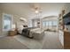 Bright main bedroom with large windows, neutral tones, ceiling fan, and seating area at 6772 Vista Lodge Loop, Castle Pines, CO 80108