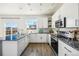 Modern kitchen features granite countertops, stainless steel appliances, and ample cabinet space at 19658 E Vassar Dr, Aurora, CO 80013