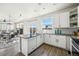 Modern kitchen featuring granite countertops, stainless steel appliances, and open to the living area at 19658 E Vassar Dr, Aurora, CO 80013