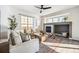 Comfortable living room featuring a fireplace and ample natural light creating an inviting space at 19658 E Vassar Dr, Aurora, CO 80013