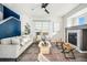 Bright and stylish living room featuring a fireplace and a large window overlooking the backyard at 19658 E Vassar Dr, Aurora, CO 80013