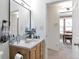 Well-lit bathroom with a vanity, mirror, and doorway to adjacent room at 14050 W 8Th Ave, Golden, CO 80401