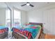 Bright bedroom with a ceiling fan, window, closet, and a colorful Spongebob themed blanket at 14050 W 8Th Ave, Golden, CO 80401