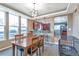 Bright dining room with wood table, large windows, and open access to the kitchen and living spaces at 14050 W 8Th Ave, Golden, CO 80401