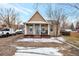 Charming single-story home featuring a cozy front porch, classic architecture, and front yard at 14050 W 8Th Ave, Golden, CO 80401