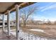 A view from the front porch, featuring white columns, a railing, and a street view at 14050 W 8Th Ave, Golden, CO 80401