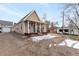 Charming single-Gathering home with a covered front porch, gravel driveway, and partial winter snow cover at 14050 W 8Th Ave, Golden, CO 80401