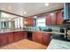 Updated kitchen featuring stainless steel appliances, granite countertops, and wood-look flooring at 14050 W 8Th Ave, Golden, CO 80401