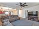Comfortable living room featuring a large sectional sofa, neutral carpet, and open access to the kitchen at 14050 W 8Th Ave, Golden, CO 80401