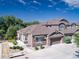 An aerial view of a lovely home with mature trees and landscaping, including a view of the attached garage at 14916 E Crestridge Pl, Centennial, CO 80015