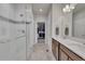 Elegant bathroom with glass-enclosed shower, dual sinks, and a walk-in closet at 14916 E Crestridge Pl, Centennial, CO 80015