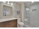 Modern bathroom featuring an enclosed glass shower with built-in seat, and vanity with a dark wood finish at 14916 E Crestridge Pl, Centennial, CO 80015