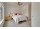 Cozy bedroom with a ceiling fan, nightstand and soft natural light coming in from the window at 14916 E Crestridge Pl, Centennial, CO 80015