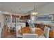 Open concept, showing a stylish dining room with hardwood floors, chandelier, and modern decor at 14916 E Crestridge Pl, Centennial, CO 80015