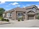 Charming home featuring a stone and siding exterior, well-manicured landscaping, and an attached two-car garage at 14916 E Crestridge Pl, Centennial, CO 80015